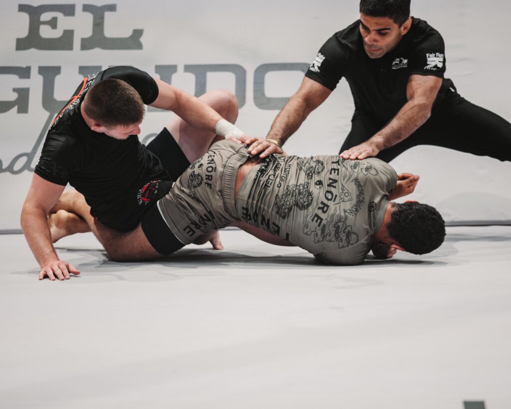 CJI competitors grappling on the mat at an event.