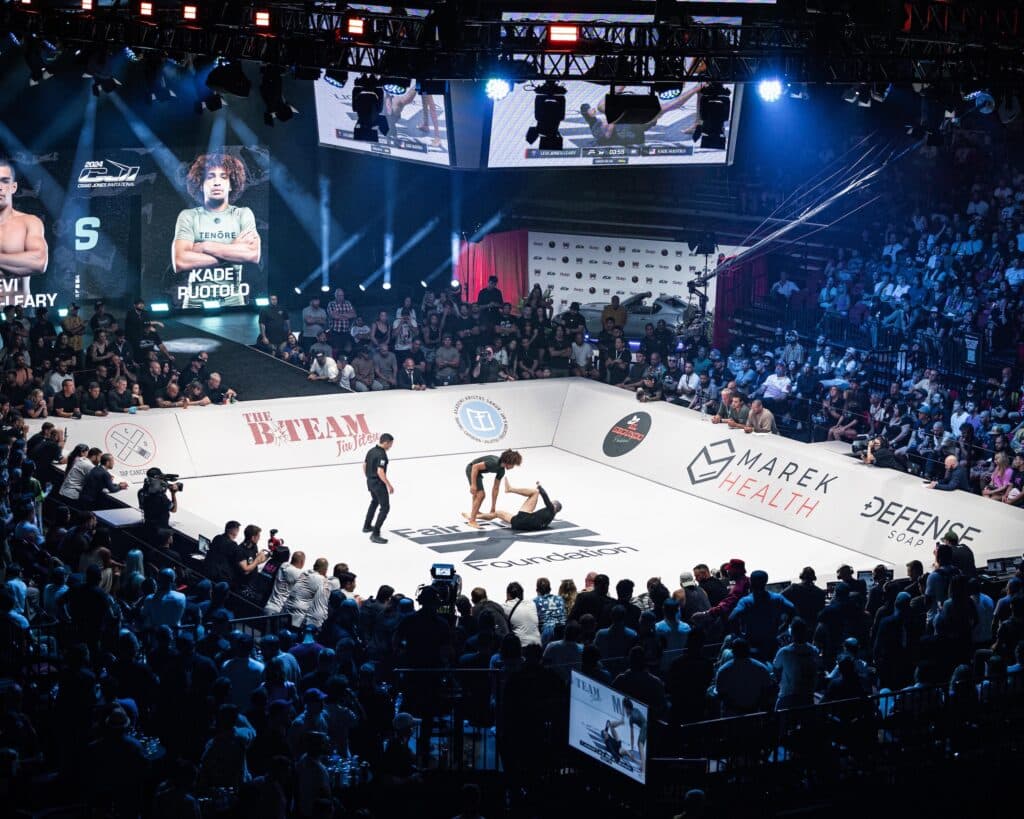 CJI competitors grappling on the mat at an event.