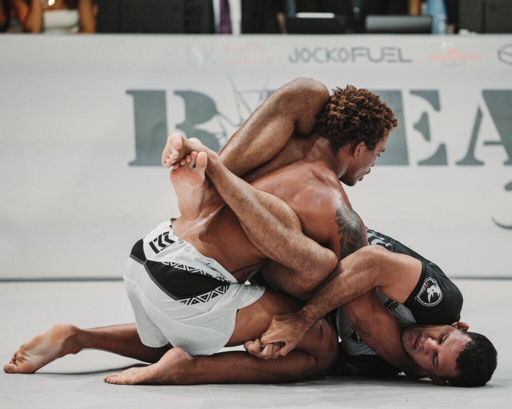 CJI competitors grappling on the mat at an event.