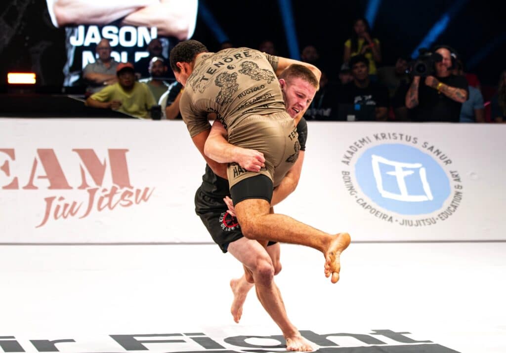 CJI competitors grappling on the mat at an event.
