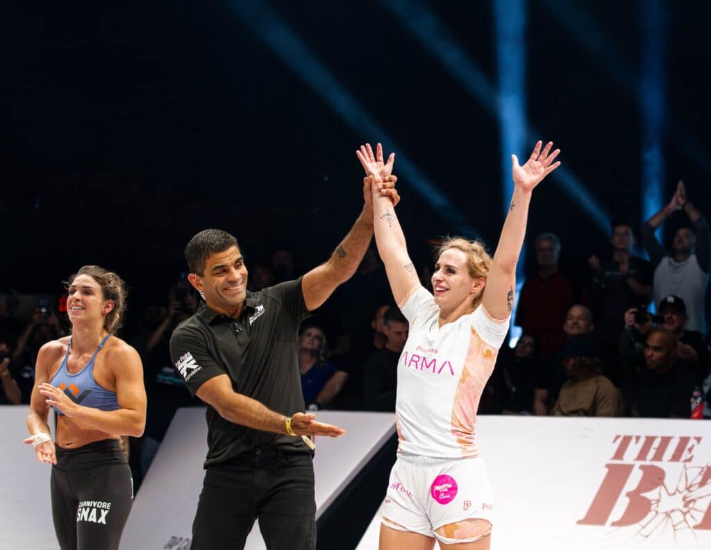 CJI competitor winner with hands held up in triumph on the mat.